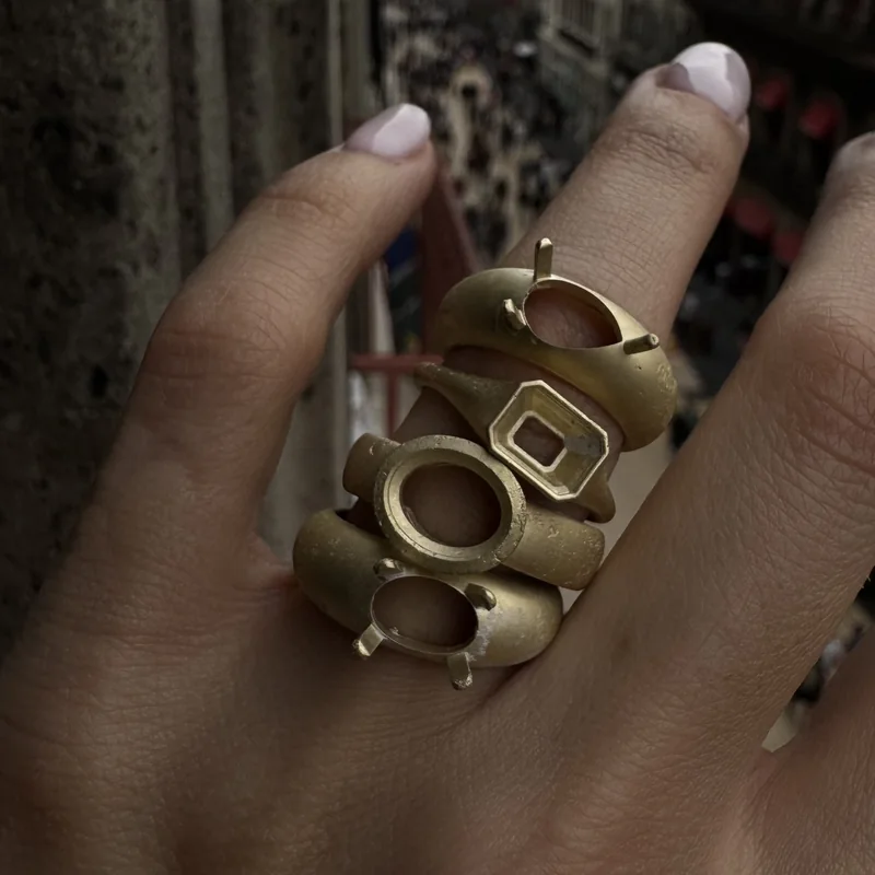 Unfinished ring mounts stacked on a hand
