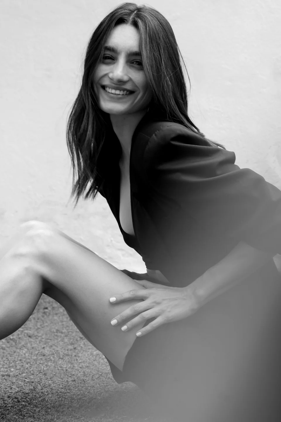 Tracy Reuss seated in a black blazer, smiling